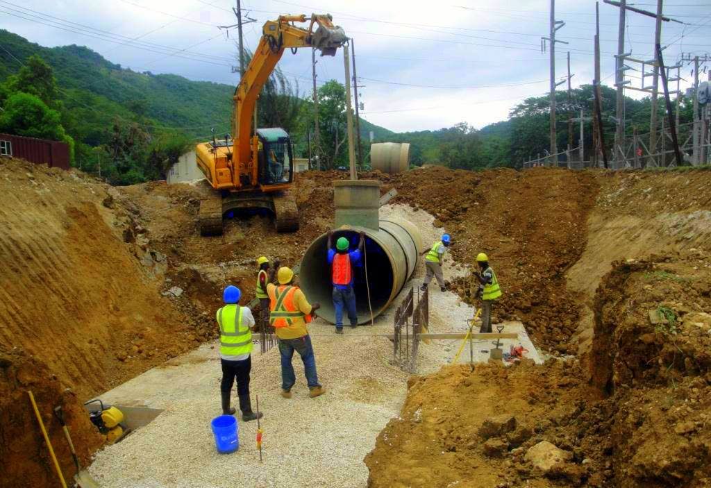 Workmen at a section of the pipeline to serve the new Maggotty Hydro Plant