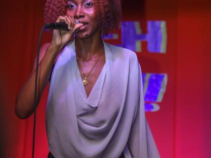 Artiste and songwriter Akina Eman steps out in a dramatic flounce top and velvet skirt.