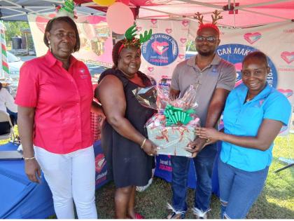 Cordell Howell-Huie (second left) and Deacon Dalmas Agan (second right)), administrators at the Mustard Seed Children’s Home in Moore Park, St James, jointly collect a gift basket from Janet Richards (left), chairman of the Janet Richards Foundation, and