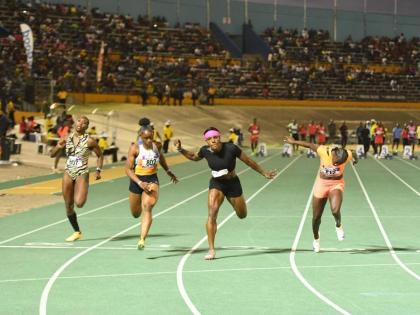 
Jonielle Smith (second right) outdips Tina Clayton (second left) during the Gibson McCook Relays 60-metre invitational women’s event at the National Stadium yesterday.