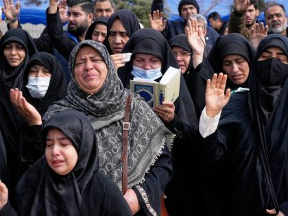 Mourners pray during the funeral of Mehdi Hosseini, a man killed in a US-Israeli strike, at Behesht-e Zahra cemetery in Tehran, Iran.