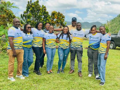 Terrence Brooks (fourth right, back row) , general manager of the Shipping Association of Jamaica with his team in Abekuta, Westmoreland, after delivering packages to residents in the area.