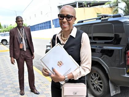 Fayval Williams, minister of finance and the public service, arrives at Gordon House yesterday with a copy of her closing presentation in the 2026-2027 Budget Debate.
