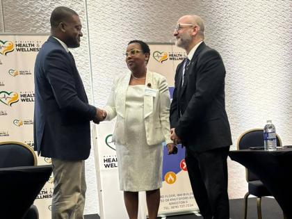 Director of the Emergency, Disaster Management and Special Services (EDMSS) Branch at the Ministry of Health and Wellness, Dr Nicole Dawkins-Wright (centre) greets Director General of the Office of Disaster Preparedness and Emergency Management (ODPEM), Co