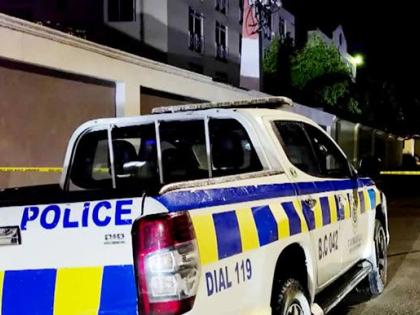 Police on the crime scene in the vicinity of Kensington Court in New Kingston on Friday night.