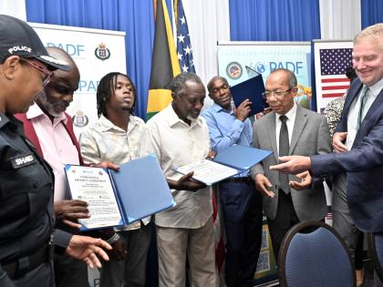 Dr Horace Chang (second right), deputy prime minister and minister of national security and peace; Scott Renner (right), charge d’affairs at the United State Embassy in Kingston; and Charmaine Shand (left), assistant commissioner of police, Community Saf