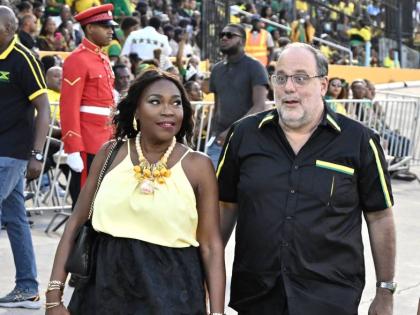 Opposition Leader Mark Golding and his wife, Sandra Golding, make a stylish statement, with Sandra in a flowing black skirt and yellow camisole, and Mark in an all-black look, accented with green and yellow.