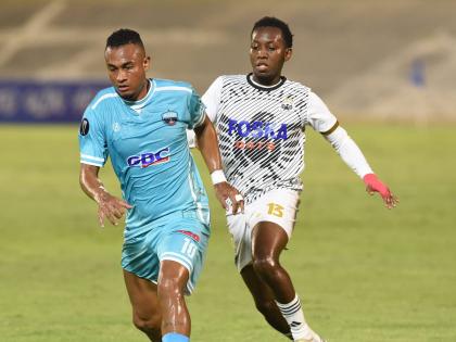 Dwayne Allen (right) of Cavalier moves to challenge Sebastian Ramos  of Salcedo FC during their Concacaf Caribbean Cup football match at the National Stadium on Thursday night. The game ended 0-0.