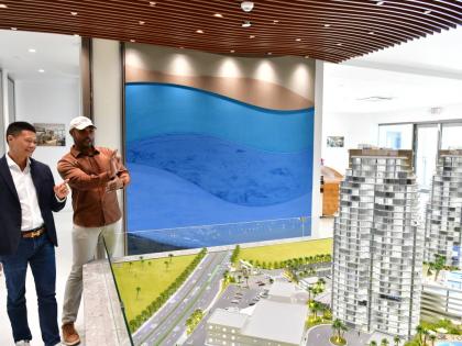 Yangsen Li (left), chief executive officer of LCH Development and developer of The Pinnacle, in conversation with Miller as the two look at a scale model of the luxury residences under construction.