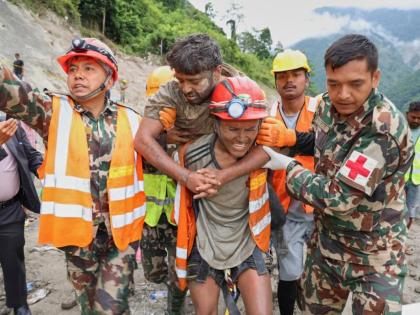 In this photo provided by the Nepal Army, soldiers rescue a worker alive from a tunnel during an ongoing operation at the Trishuli-3A hydropower project in Nepal's Rasuwa district on Friday. - AP photo