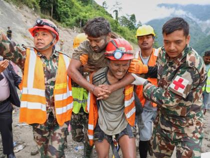 Soldiers rescue a worker alive from a tunnel during an ongoing operation at the Trishuli-3A hydropower project in Nepal’s Rasuwa district, Friday.