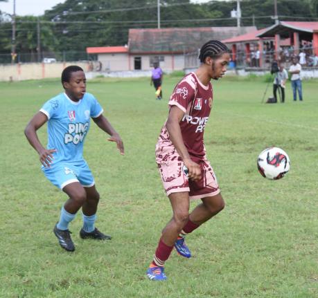 Herbert Morrison Technical High School's Amere Brown (right) shields the ball from Maldon High's Alikay McFarlane during their ISSA daCosta Cup Zone A football match at the Herbert Morrison High play field yesterday. Herbert Morrison won 1-0.